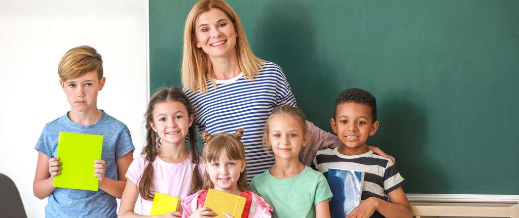 Cute children with teacher in classroom